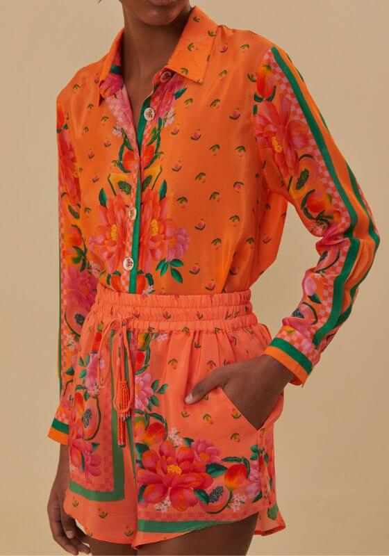 Fruit Garden Scarf Shorts by Farm Rio, vibrant floral print shorts with tie waist and relaxed fit, styled with a matching shirt.