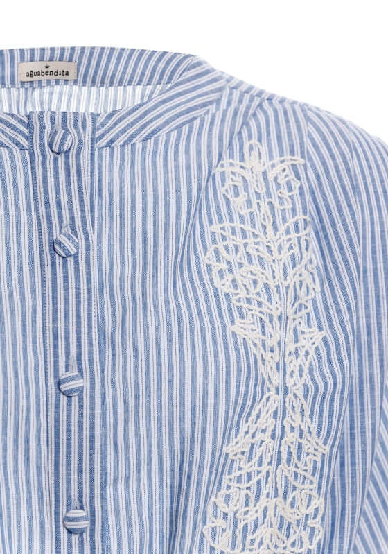 Isolda Batik Top by Agua Bendita, featuring delicate white embroidery on blue striped fabric.