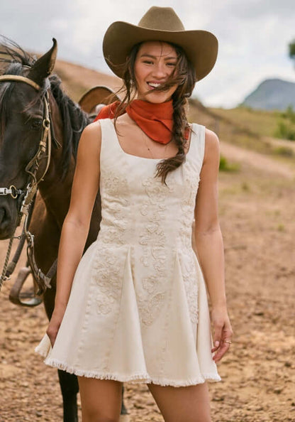 Kristen Sereia Dress by Agua Bendita on a model outdoors, featuring a structured bodice and pleated skirt.