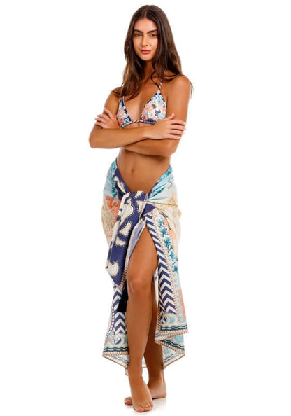Marine Sereia Sarong by Agua Bendita worn as a skirt, showcasing stunning print and handmade tassels.