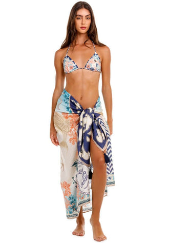 Marine Sereia Sarong by Agua Bendita, featuring coral reefs and seashells, worn stylishly with handmade tassels.