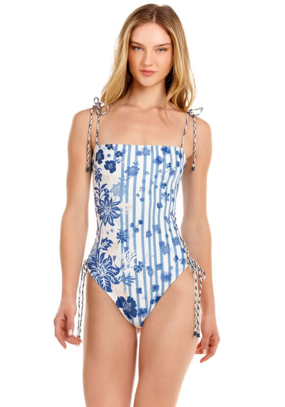 Posh Batik Swimsuit by Agua Bendita, showcasing a stylish blue floral design with adjustable lace-up sides.