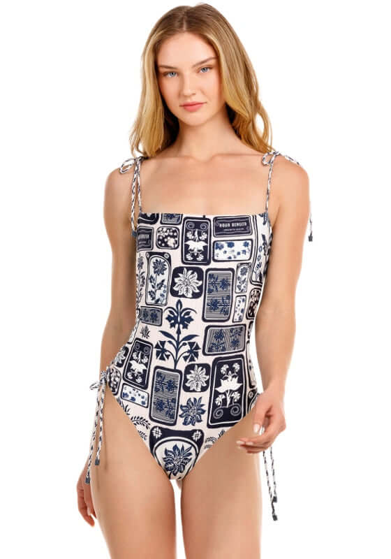 Posh Batik Swimsuit by Agua Bendita worn by a model showcasing intricate patterns and lace-up side details.