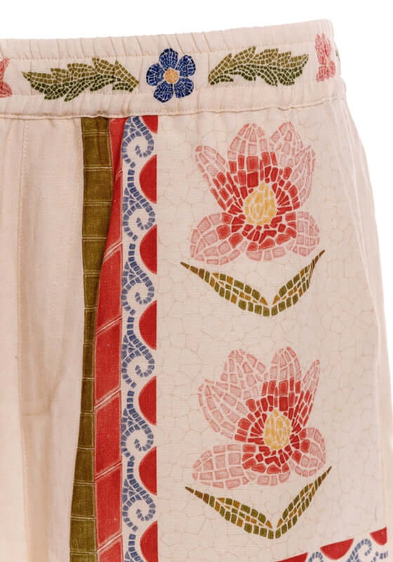 Watts Fiore Beach Shorts by Agua Bendita featuring a floral print and elastic waistband.
