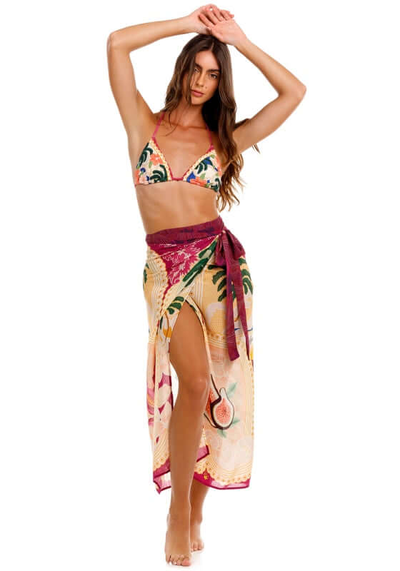 Zinna Thamar Sarong by Agua Bendita, model wearing colorful tropical wrapped sarong at the beach.