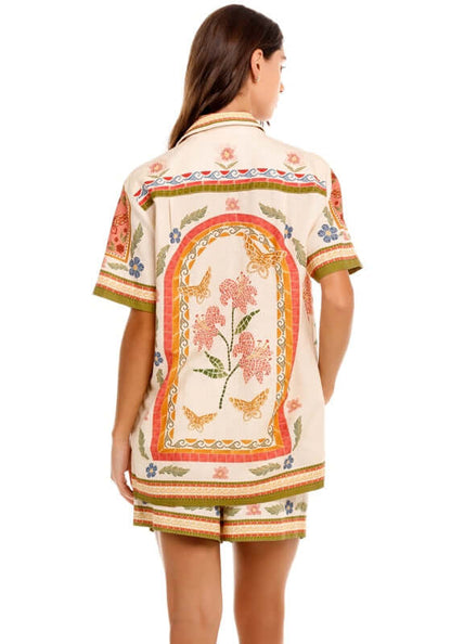Ali Fiore Beach Shirt by Agua Bendita, featuring a colorful floral print on the back with short sleeves.
