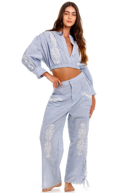 Oprah Batik Beach Trousers by Agua Bendita, featuring a model wearing a blue striped outfit with embroidery and wide legs.
