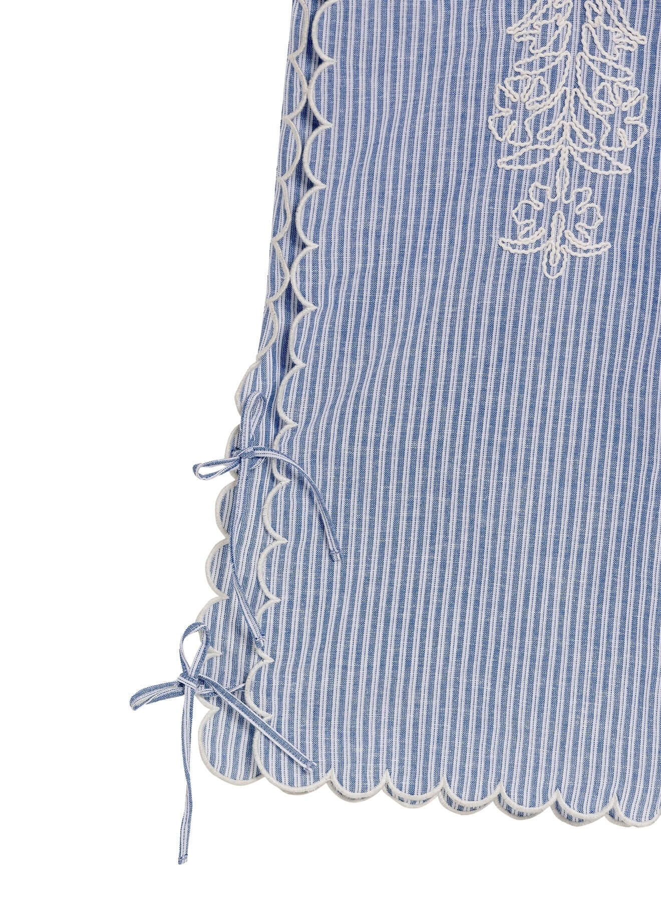 Oprah Batik Beach Trousers by Agua Bendita showing striped fabric with embroidered patterns and lace-up hem details.