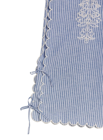 Oprah Batik Beach Trousers by Agua Bendita showing striped fabric with embroidered patterns and lace-up hem details.