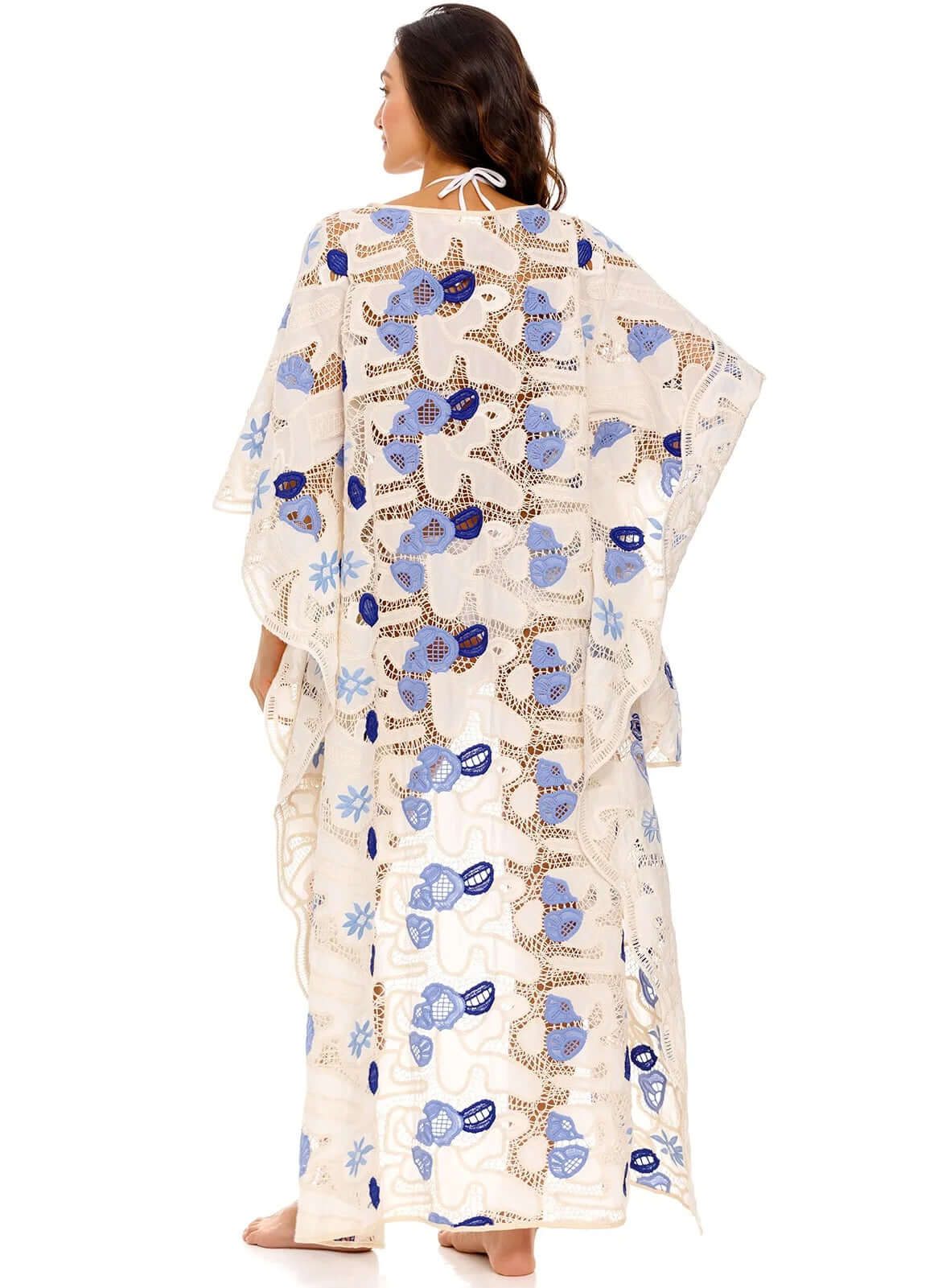 Dara Tunic Tales by Agua Bendita, featuring a woman wearing an eyelet kaftan with floral print from the back.