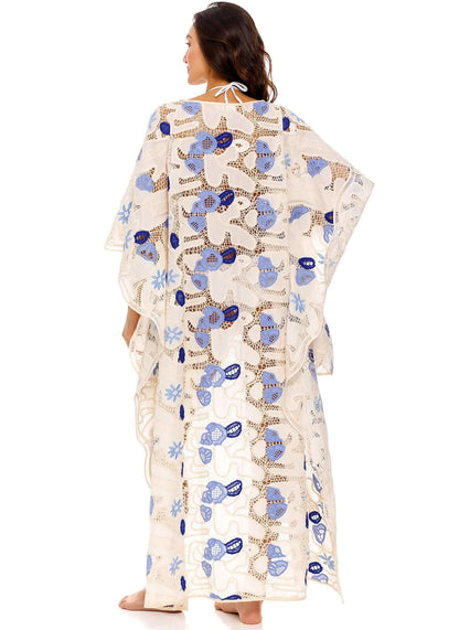 Dara Tunic Tales by Agua Bendita, featuring a woman wearing an eyelet kaftan with floral print from the back.