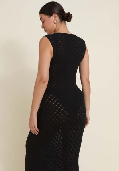 Dominica Dress Black by Away That Day, showcasing intricate crochet detailing and a flattering silhouette from the back.