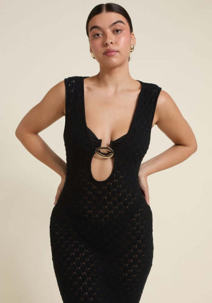 Dominica Dress Black by Away That Day showing a model wearing a crochet maxi with a keyhole cutout and gold accents.