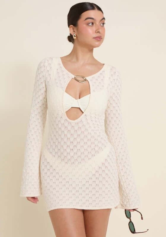 Havana Dress Ivory by Away That Day, featuring bell sleeves and a gold buckle detail, perfect for the beach.
