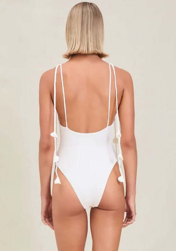 Carmela Swimsuit Dove by Devon Windsor, showcasing the elegant back design with delicate flower details on tie straps.