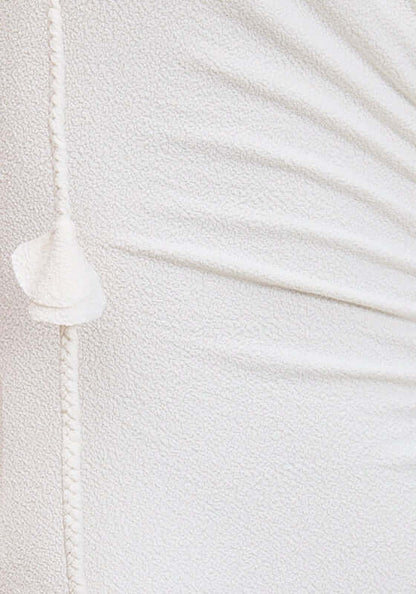 Carmela Swimsuit Dove by Devon Windsor close-up of ruched white fabric detail and charming flower tie strap.