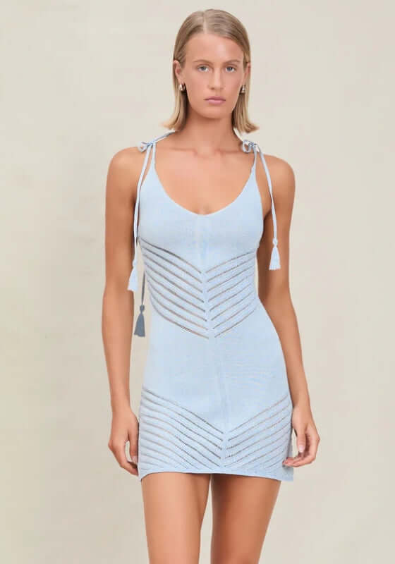Halle Dress Azure by Devon Windsor, a fine knit blue dress with V neckline, adjustable spaghetti straps, and tassel details.