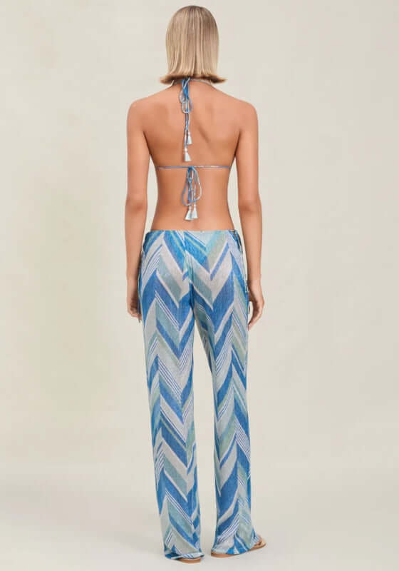 Ollie Beach Trousers Glacier by Devon Windsor, featuring a back view of a model in wide-leg trousers with chevron sparkly print.