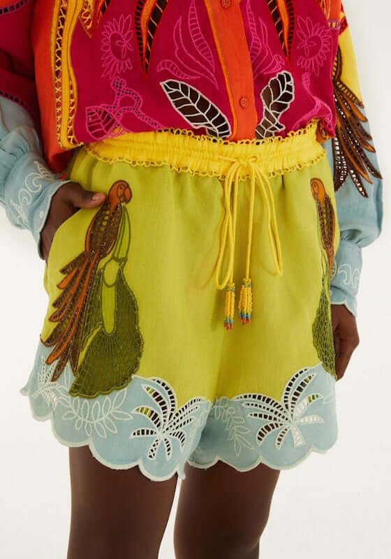 Usiacuri Embroidered Richelieu Shorts by Farm Rio with tropical patterns and blue scalloped hem, perfect for beachwear.