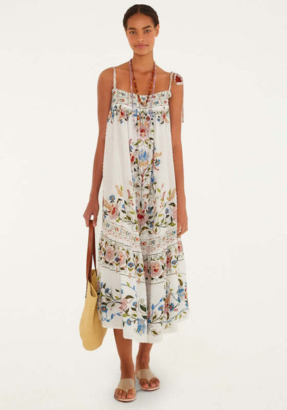 Stitched Garden Off White Long Dress by Farm Rio model wearing a flowy dress with floral patterns, relaxed fit, and adjustable tie straps.