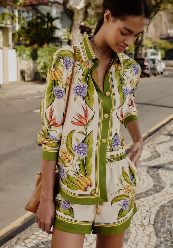 Tropical Scarf Shorts Sand by Farm Rio, showcasing a model wearing a colorful shirt and shorts in a vibrant outdoor setting.