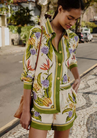 Tropical Scarf Shorts Sand by Farm Rio, showcasing a model wearing a colorful shirt and shorts in a vibrant outdoor setting.