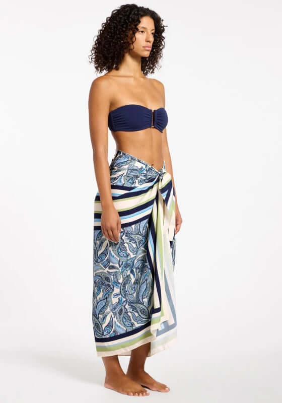 Oasis Paisley Sarong Ink by Jets worn as a stylish cover-up showcasing navy, white, and green paisley patterns.