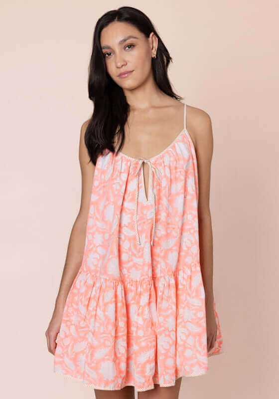Pomegranate Strappy Mini Dress Neon Red by Juliet Dunn, featuring adjustable spaghetti straps and a tie front for a stylish fit.