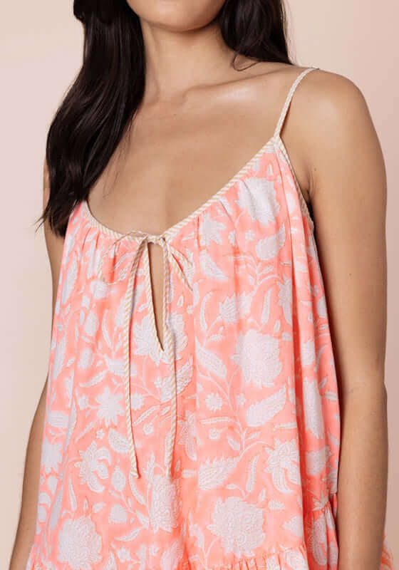 Pomegranate Strappy Mini Dress Neon Red by Juliet Dunn, featuring adjustable spaghetti straps and a tie front for a customizable fit.
