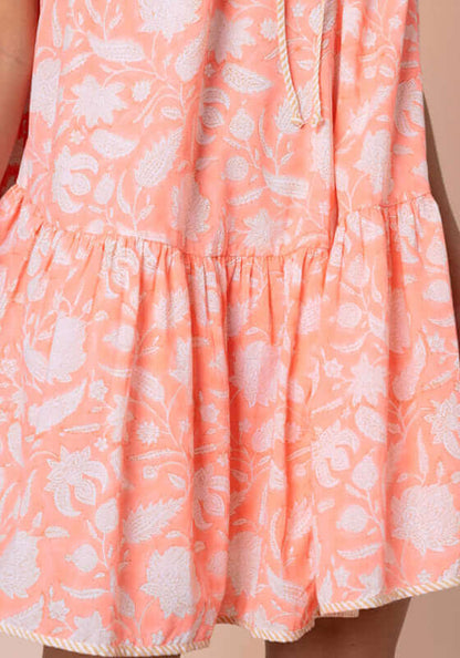 Pomegranate Strappy Mini Dress Neon Red by Juliet Dunn, close-up of floral fabric detail and ruffled hem design.