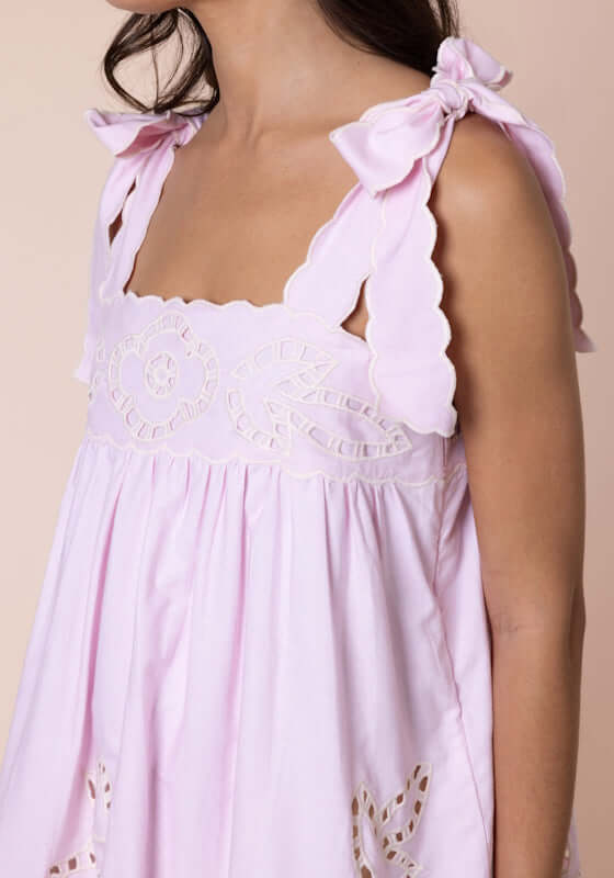 Cutwork Baby Doll Dress Petal Pink by Juliet Dunn, showcasing delicate tie shoulder straps and scalloped embroidery.