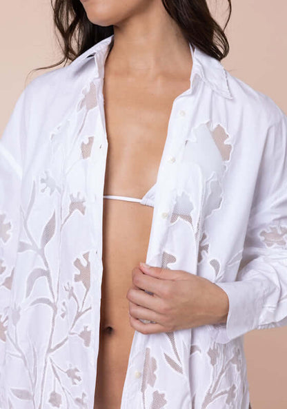 Floral Cutwork Shirt White by Juliet Dunn modeled with intricate floral cutwork over a bikini top.