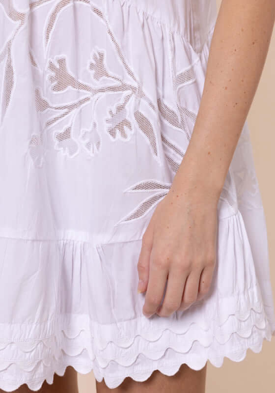 Floral Cutwork V Neck Mini Dress White by Juliet Dunn, showcasing intricate floral cutwork and embroidered scalloped hem.