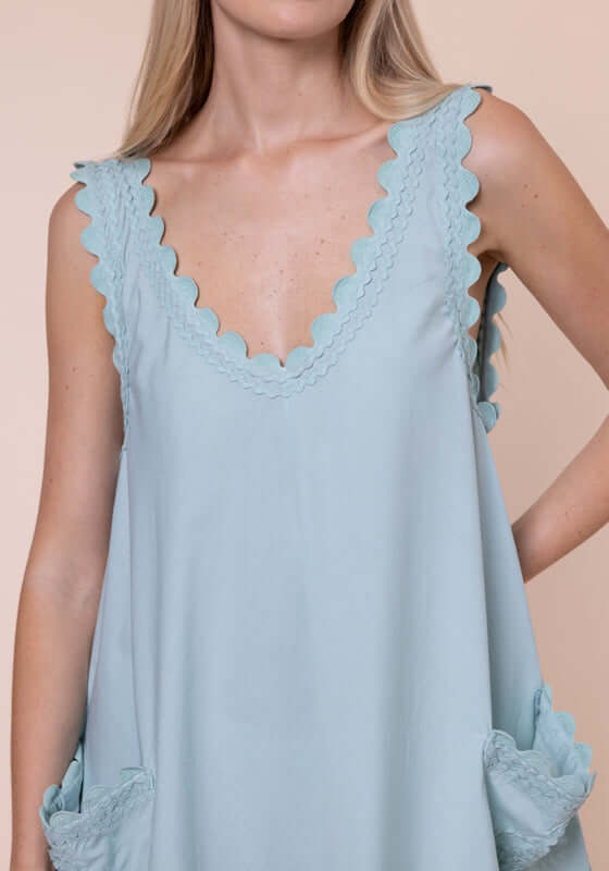 Ric Rac Low Back Dress Pistachio by Juliet Dunn, detailed view of the scalloped neckline and patch pockets.