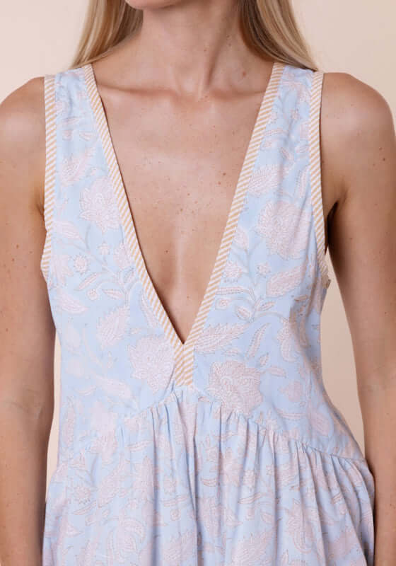 Pomegranate Print V Neck Dress Ice Blue by Juliet Dunn, featuring a deep V neckline and ice blue fabric with pale orange piping.