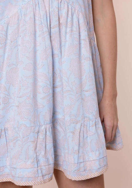 Pomegranate Print V Neck Dress Ice Blue by Juliet Dunn, featuring a light blue fabric with pale orange floral detail.