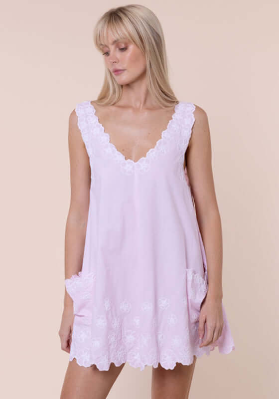 Poplin Floral Low Back Dress Petal Pink by Juliet Dunn, showcasing a light pink dress with lace trim and patch pockets.