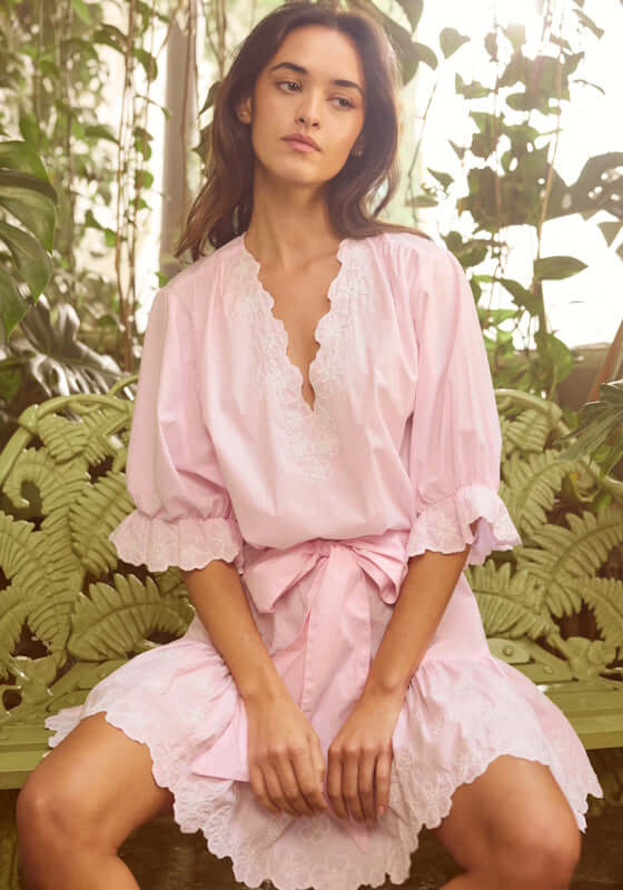 Poplin Floral Tie Waist Dress Petal Pink by Juliet Dunn model wearing soft pink dress with floral details in a botanical setting.