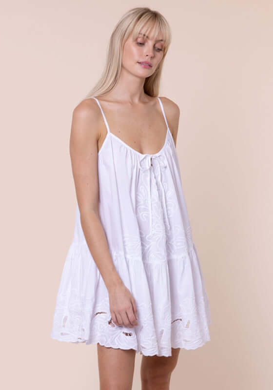 Poplin Strappy Dress White by Juliet Dunn, model wearing a white cutout embroidered poplin dress with adjustable straps.