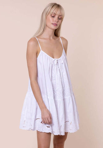 Poplin Strappy Dress White by Juliet Dunn, model wearing a white cutout embroidered poplin dress with adjustable straps.