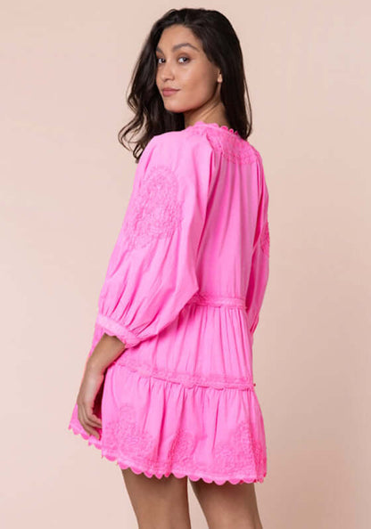 Ric Rac Tiered Mini Dress Hot Pink by Juliet Dunn, model showing back view of vibrant dress with ruffled hem and embroidery details.