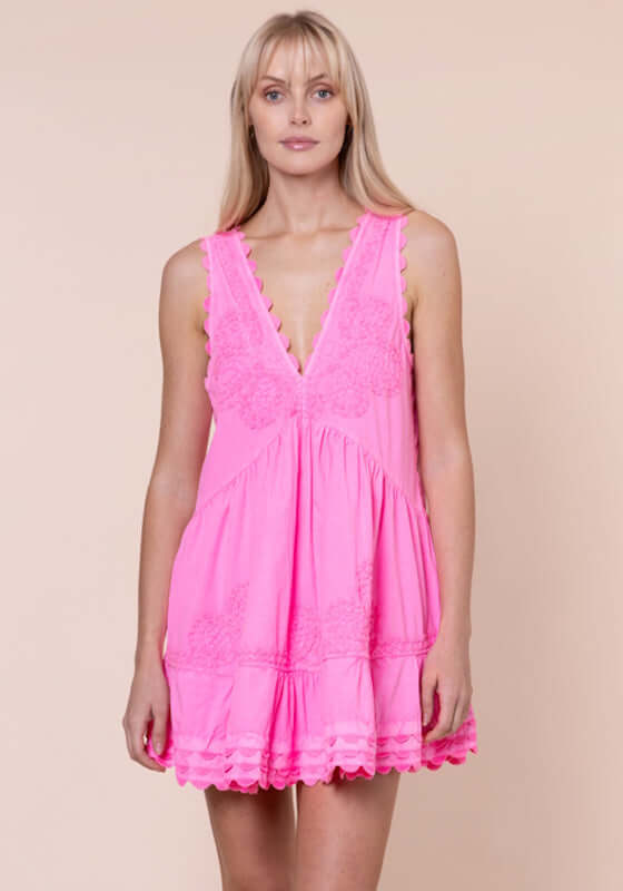 Ric Rac V Neck Dress Hot Pink by Juliet Dunn, model wearing a vibrant hot pink dress with V neckline and ric rac detailing.