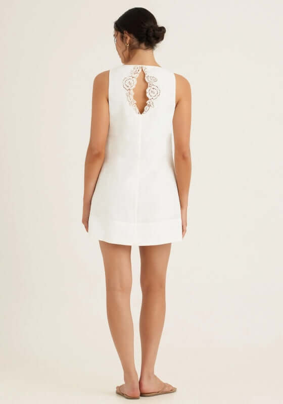 Embroidered Keyhole Mini Dress Gardenia by Peony, showcasing a relaxed white linen mini dress with an intricate back cutout.