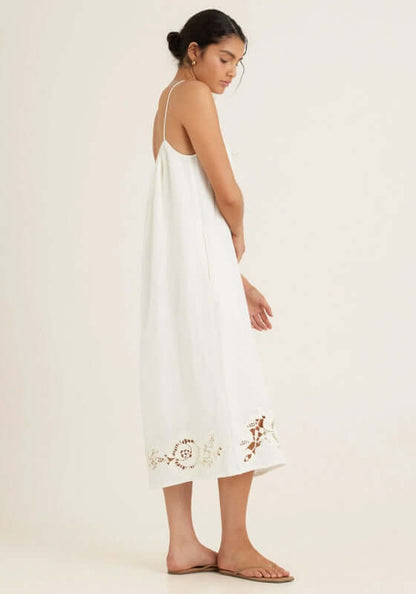 Embroidered Midi Dress Gardenia by Peony, showcasing a loose-fitted white dress with intricate cutout embroidery at the hem.