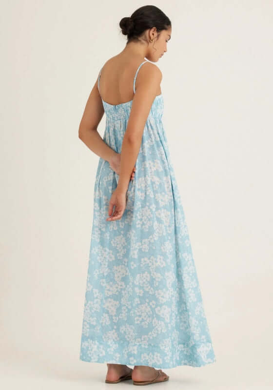 Everlasting Maxi Dress Paper Daisy by Peony, showcasing the back view with a blue and white daisy print and flowing silhouette.