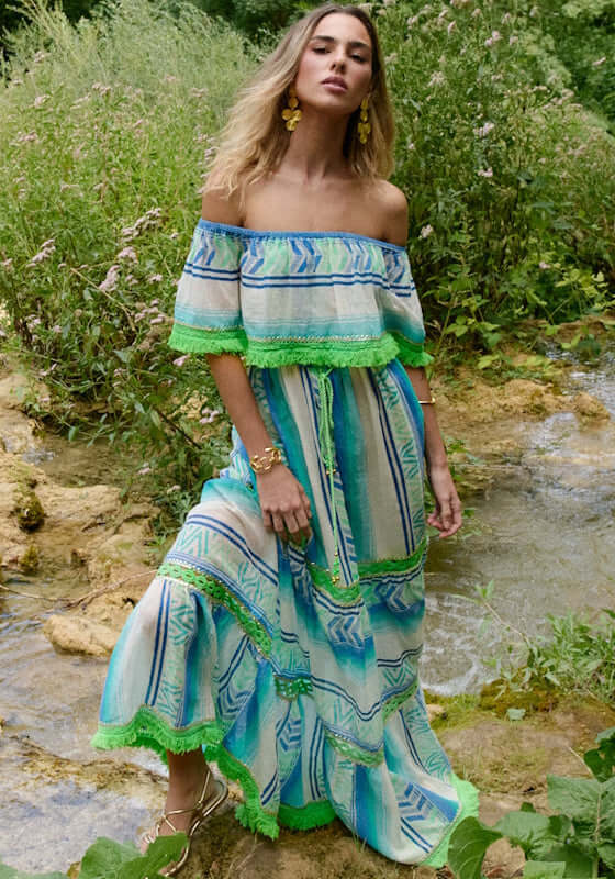 Frida Long Dress Aqua by Piti Cuiti, featuring an off-shoulder design and flowing silhouette in vibrant aqua and green tones.