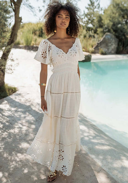 Florencia Dress Natural by Piti Cuiti, featuring a V-neckline, open back, and delicate embroidery by the pool.