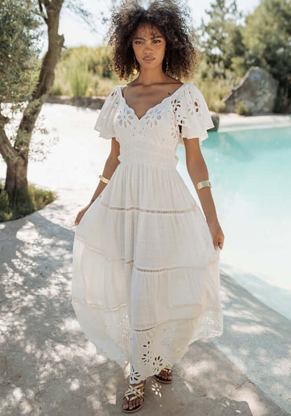 Florencia Dress Natural by Piti Cuiti, a breezy white dress with floral embroidery, V-neckline, and open back.