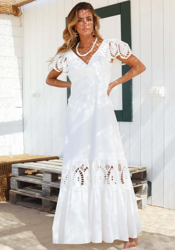 Copacabana Dress White by Sole Lisboa, featuring a V-neckline and eyelet cutouts, perfect for warm beach days.