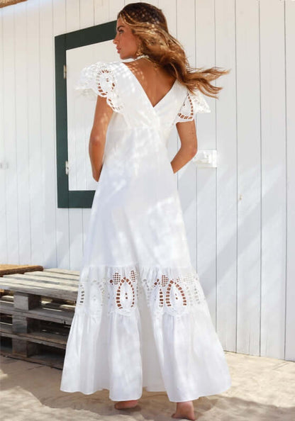 Copacabana Dress White by Sole Lisboa, featuring a V-neckline, peplum skirt, and eyelet cutout details on a model.